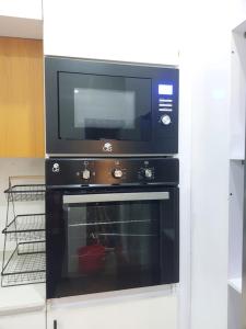 a microwave sitting on top of an oven at 2 bedroom Apartment Lekki Ovation Terrace in Lekki