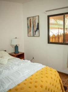 a bedroom with a white bed and a window at La Pérgola lodge in Sarapiquí