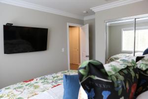 a bedroom with a bed and a flat screen tv at Destination #37 in Fullerton
