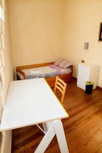 a small room with a table and a bed at A un passo dal centro gli orsetti del duomo in Piacenza