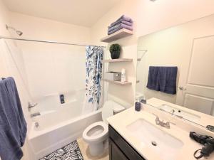 a bathroom with a sink and a toilet and a shower at 2-Bedroom Entire Guest Suite in North Las Vegas Mountain Views in Las Vegas +15 photos