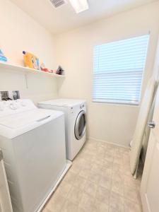 a white laundry room with a washer and dryer at 2-Bedroom Entire Guest Suite in North Las Vegas Mountain Views in Las Vegas