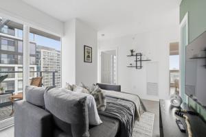 a bedroom with a bed and a large window at Modern Downtown Retreat 3BR Condo with Patio in Toronto