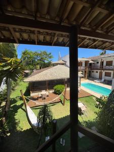 a view of a resort with a hammock and a pool at Pousada Tetiaroa in Barra Grande