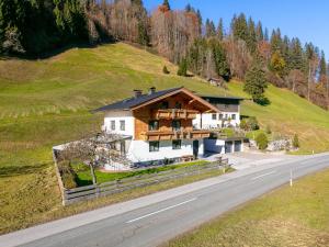 a house on the side of a hill with a road at Gastl in Hopfgarten im Brixental