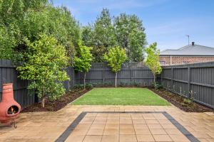Geelong WestMia's Place Modern Pet friendly Geelong West stay的后院设有栅栏和草地庭院