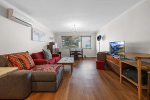 a living room with a couch and a table at Beach Retreat in Warrnambool