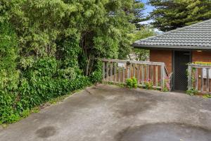 a driveway in front of a house with a fence at Beach Retreat in Warrnambool