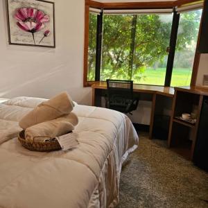 a bedroom with a bed with a desk and a window at Green Palace Hotel Boutique in Asuncion