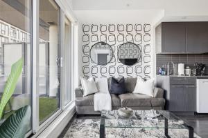 a living room with a couch and a table at Bright Downtown Condo with City Views & Comfort in Toronto