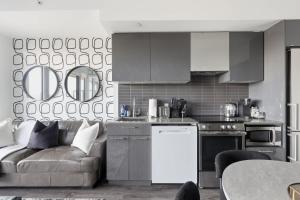 a kitchen with a couch and a table in a room at Bright Downtown Condo with City Views & Comfort in Toronto