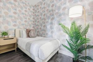 a bedroom with a bed and a plant in it at Bright Downtown Condo with City Views & Comfort in Toronto
