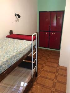 a bunk bed in a room with a red door at The Grapevine Hostel in Mendoza