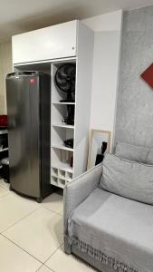 a living room with a refrigerator and a couch at Praia dos Carneiros Flat Hotel Fantástico in Tamandaré +39 photos