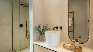 a bathroom with a sink and a mirror at NAMA Suites in Hersonissos