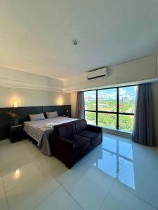 Ένα ή περισσότερα κρεβάτια σε δωμάτιο στο Loft vista ponta negra +9 φωτογραφίες