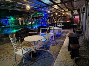 a group of tables and chairs in a room at 8 dragon resort standard rooms in Silang