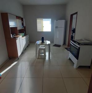 a kitchen with a small table and a refrigerator at Casa da Meire in Prado