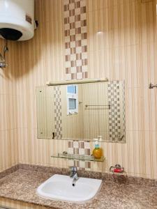 a bathroom with a sink and a mirror at Terhal guest house in Muscat