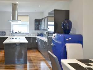 a kitchen with a blue refrigerator and a table at The View Old Coastguard Cottage in Tynemouth +31 photos