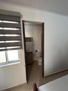 a bathroom with a toilet and a window at Apartamento Roldanillo in Roldanillo +6 photos