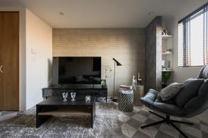 a living room with a couch and a chair at Skytree View Riverside Terrace in Tokyo