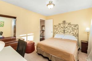 a bedroom with a bed and a table and a desk at Spacious 5BR Retreat with Private Suite Sleeps 12 in Mississauga