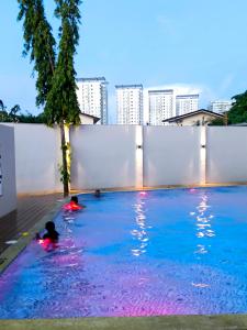 two children swimming in a swimming pool in a city at BH UrbanSky Condo in Mactan +15 photos