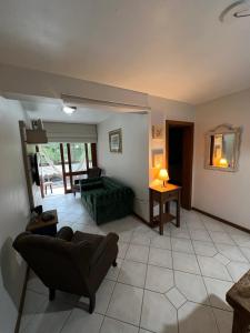 a living room with a couch and a table at Meu cantinho in Canela