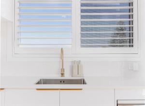 a kitchen with a sink and a window at The Sand Box in Kingscliff +23 photos