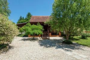 a house with a tree in front of it at Family friendly house with a swimming pool Varazdin Breg, Zagorje - 24411 in Sveti Ilija