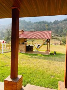a view of a park with a playground with a slide at Cabaña Brisa Andina in Tibaná