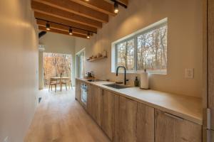 a kitchen with wooden cabinets and a large window at The Klover in Logan