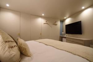 Ένα ή περισσότερα κρεβάτια σε δωμάτιο στο 備瀬縁梵 bise-enpu +25 φωτογραφίες