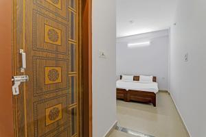 a door leading to a bedroom with a bed at Hotel O Fine Stay Guest House in Bhauli +18 photos