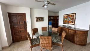 a dining room with a glass table and chairs at Beachfront apartment in Salinas Malecom in Salinas