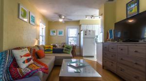 a living room with a couch and a kitchen at 1BR 1BA NorthStar Bungalow. Just Steps to the beach and the bay. in St Pete Beach