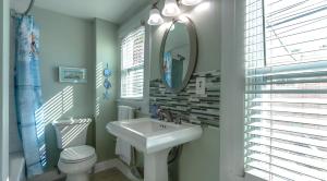 a bathroom with a sink and a toilet and a mirror at 1BR 1BA NorthStar Bungalow. Just Steps to the beach and the bay. in St Pete Beach +43 photos