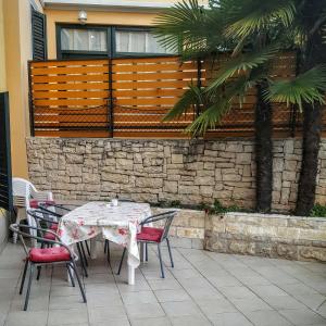 a table and chairs sitting on a patio at Holiday House Sara in Opatija