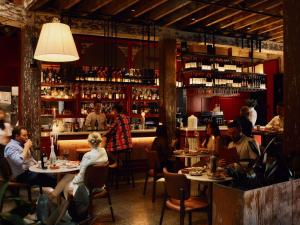 a group of people sitting at tables in a restaurant at Hotel Woolstore 1888, Sydney - Handwritten Collection in Sydney