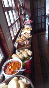 a bunch of sandwiches and other food on a buffet at Solo Buziano Guest House in Búzios