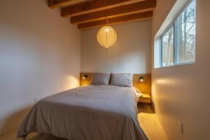 a bedroom with a bed and a large window at The Klover in Logan