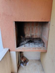 a brick oven with its door open in a room at Dpto Centro de Carlos Paz - Avellana in Villa Carlos Paz