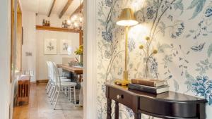 a dining room with blue and white wallpaper at Cordelia by AvantStay Amazing Backyard 10mins from Stockbridge in Lee