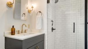 a white bathroom with a sink and a shower at Cordelia by AvantStay Amazing Backyard 10mins from Stockbridge in Lee +27 photos