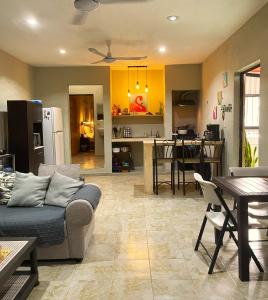 a living room with a couch and a kitchen at Casa Rio Lagartos in Río Lagartos