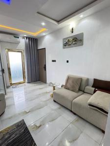 a living room with a couch and a table at Wii Apartments and Suites in Mama