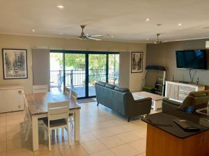 a living room with a couch and a table at Black Wattle Bungalow 30 Lake Bennett in Lake Bennett