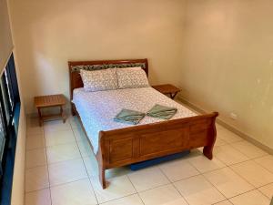 a bedroom with a bed with a bow on it at Black Wattle Bungalow 30 Lake Bennett in Lake Bennett