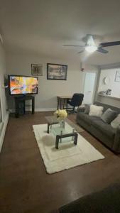 a living room with a couch and a flat screen tv at Luxurious Two Bedroom Apartment in Burlington